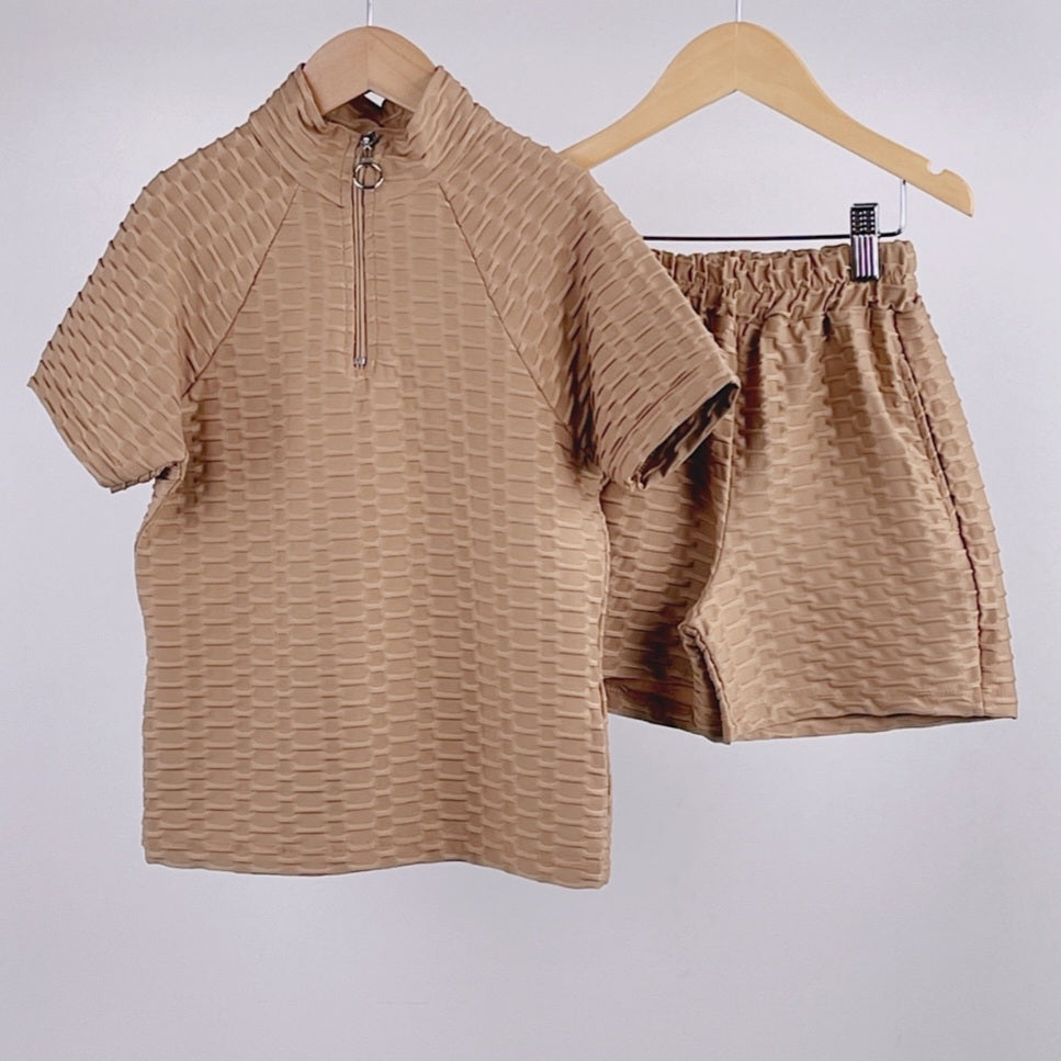 Kids beige two piece lounge set including high neck bobble motif half-zip top paired with co-ord shorts set